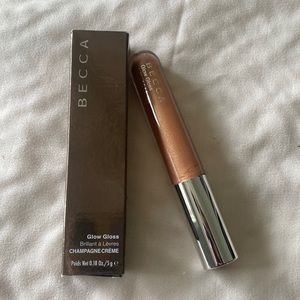 BECCA Glow Gloss. Champagne Cream Glow Gloss.  Full size. New in box.